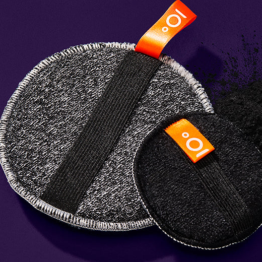 Two reusable menstrual pads with orange 'o.' logo on a purple background