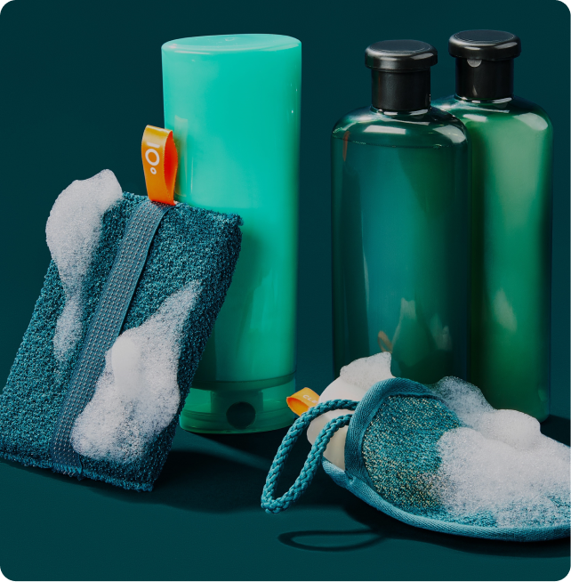 Green cleaning products with a scrubber and cloth on a dark green background